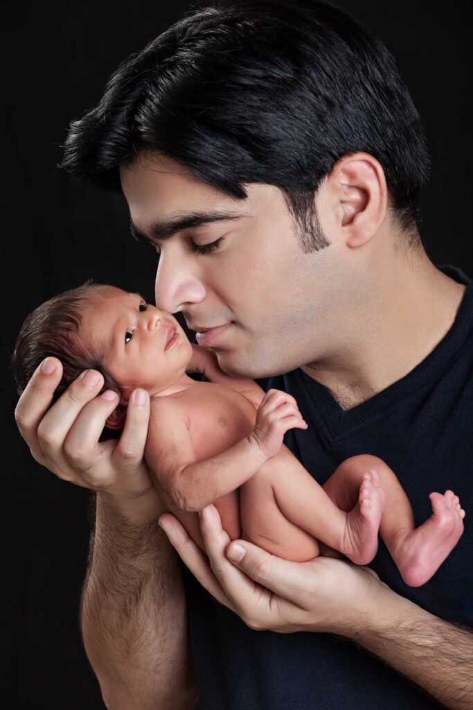 newborn with father. this photoshoot was done in swaaz studio by vikramsingh